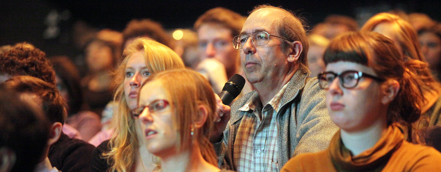 People in the audience at a public debate.