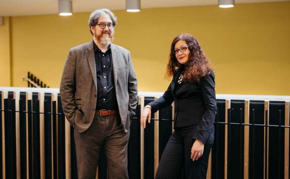 Professor Jonathan Sapsed and Dr Sara Maioli of Newcastle University Business School standing at the top of stairs in the Frederick Douglass Centre.