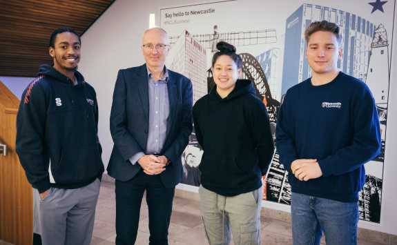 Basketball scholarship students Vivian Woo, Thomas Horvat, Daniel Delsol-Lowry and Nicolas Johnson standing in the foyer of Newcastle University Business School with Dean Stewart Robinson.