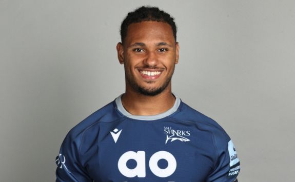 Headshot of Obi Ene, Newcastle University Business School student and professional rugby player, in Sale Sharks rugby kit. 