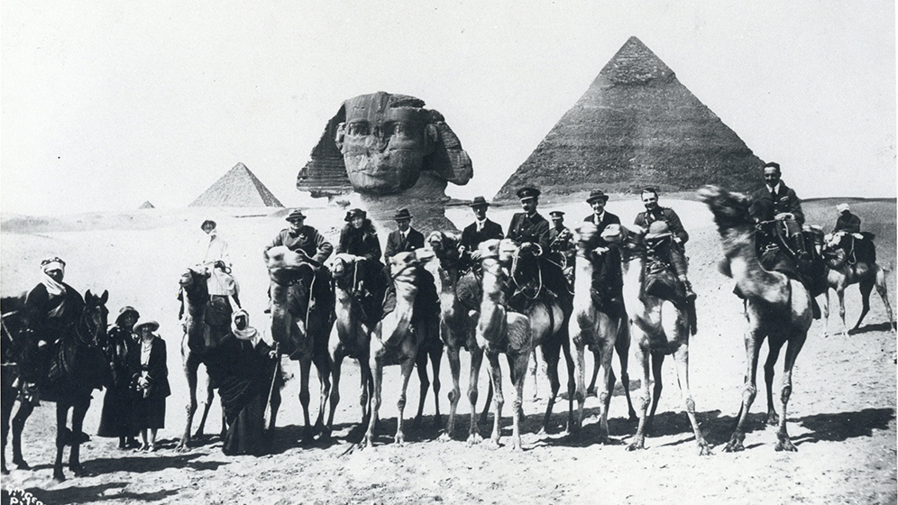 Photograph of Gertrude Bell and group on camels involved in the Cairo Conference