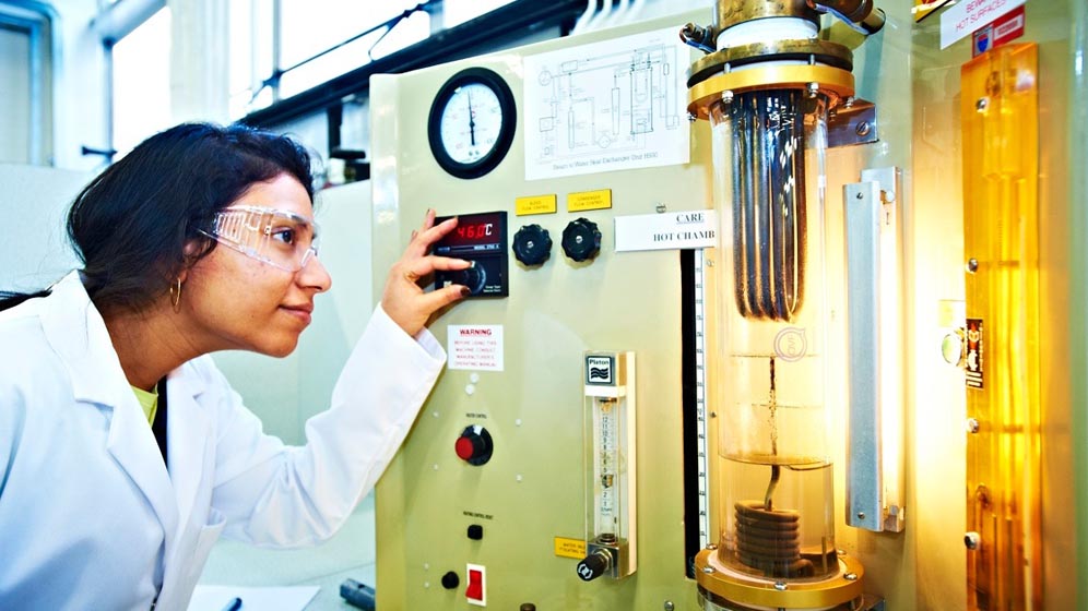 A student working with chemical engineering equipment