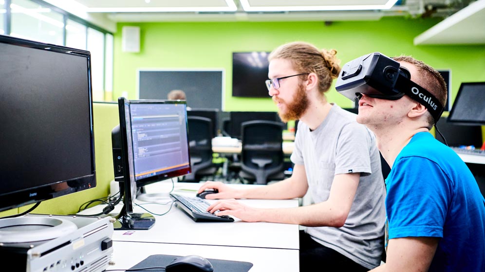 A student sits with a VR headset on