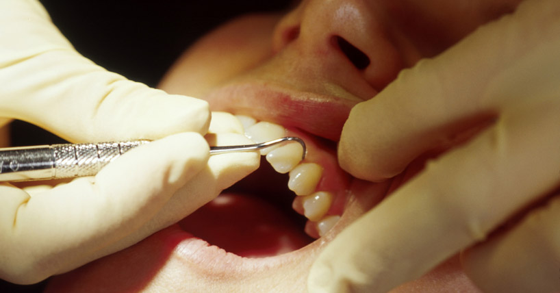 Dentist treating patient's teeth
