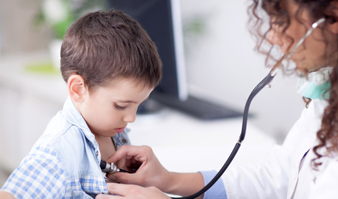 Young GP examining a child patient