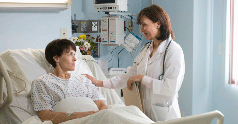 NHS hospital with female patient in bed