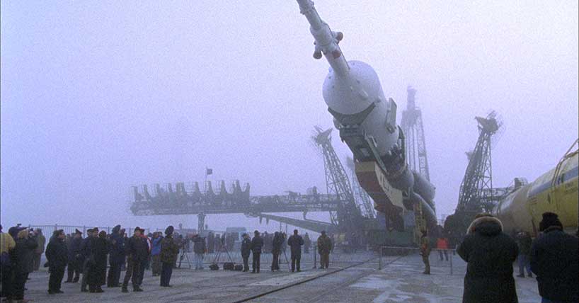 The image shows a rocket at the Baikonur Cosmodrome in Kazakhstan.