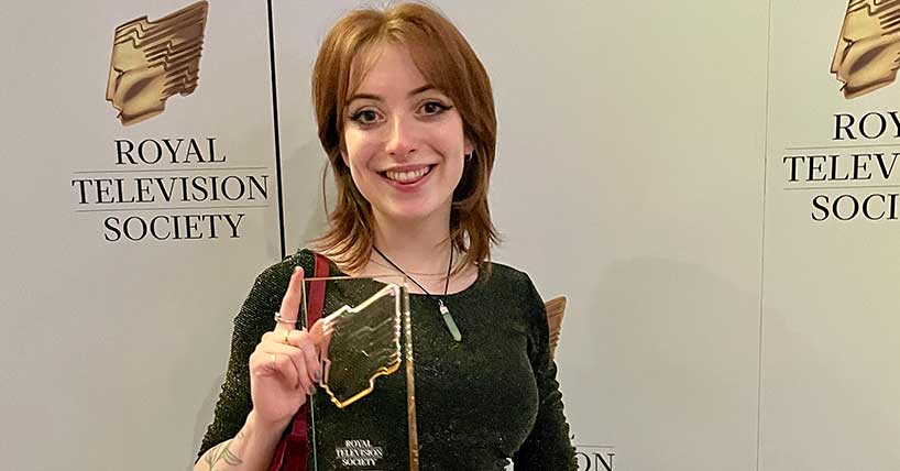 A photograph of Newcastle University graduate Olivia Barnett-Brown holding her RTS Student Award.