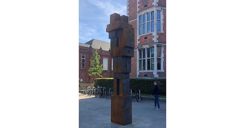 A photograph of CLASP by Antony Gormley, a 4.34 metre cast iron sculpture