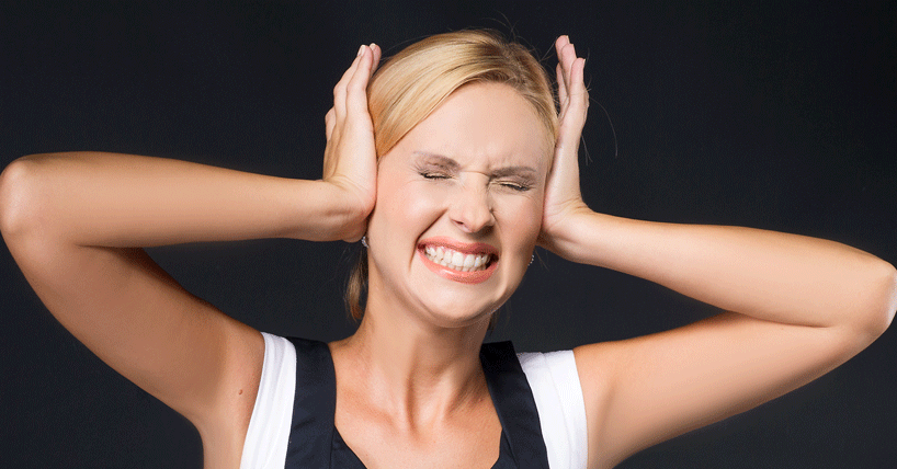 woman covering her ears in distress