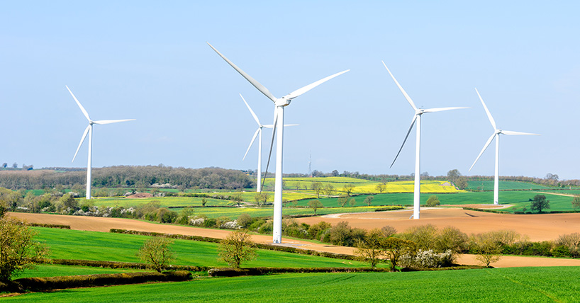 Wind Turbines and Blue Sky with Clouds over UK fields