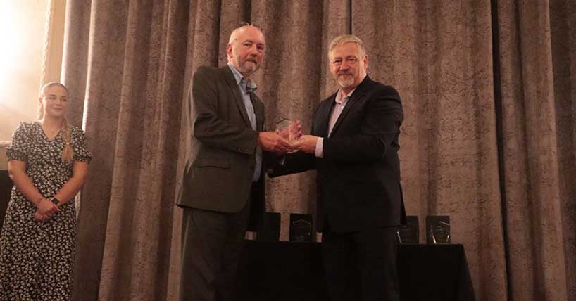 Professor Peter Stone, on left, being presented by Andy Davis with the IAASF Cultural Protection Ambassador Award ©Trident Manor 2023.