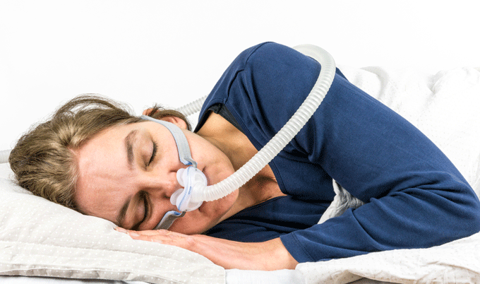 woman with sleep apnea wearing mask