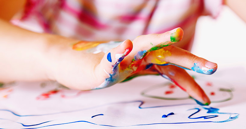 young girl painting with colorful hands young girl painting with colorful hands