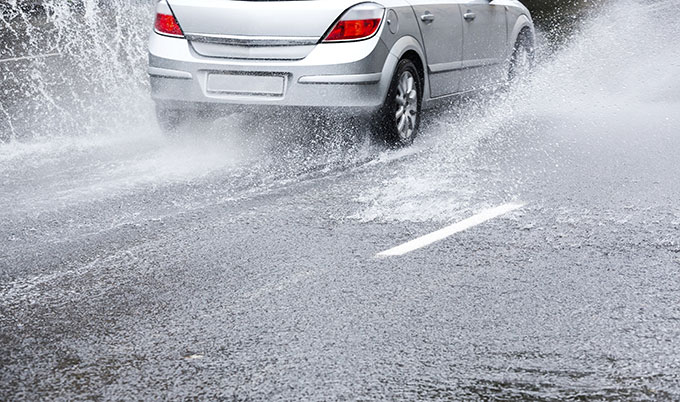 car driving through heavy rain