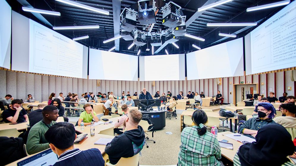 A photo showing a lecture theatre where the screen project system covers 360 degrees around the room.