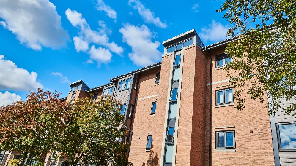 A close up photo of the exterior of Bowsden Court, taken on a sunny day with blue skies.