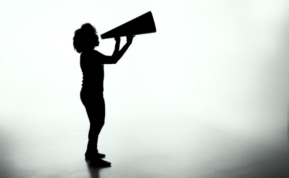 A person shouts into a megaphone