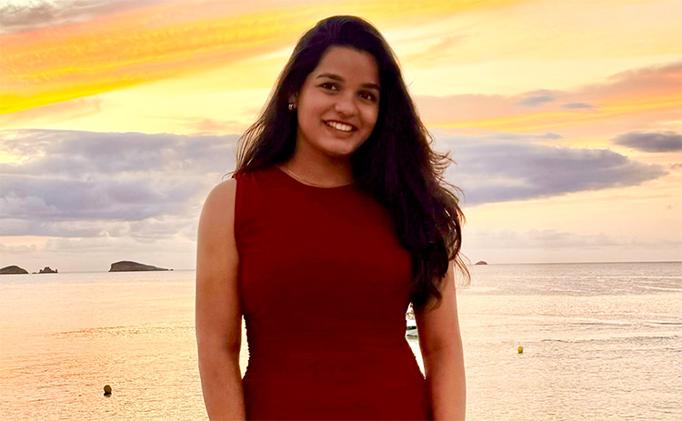 Akshita Ananthula standing on a beach at sunset	