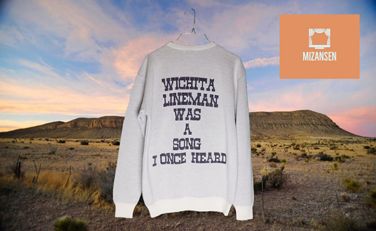 A white sweatshirt with bold black text reading