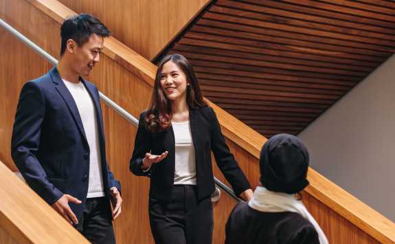 Student chatting while walking down a staircase