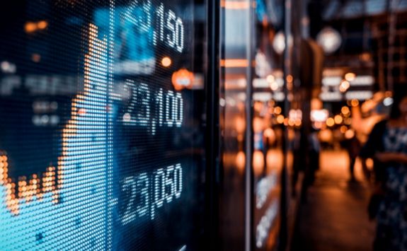 Financial stock exchange market display screen board on the street with selective focus