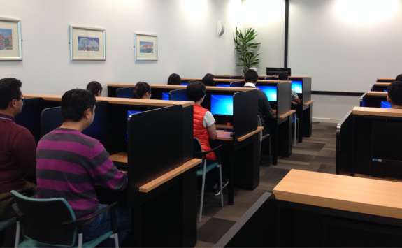 Newcastle University Business School students sat at workstations in the on-site Behavioural and Experimental Economics Computer Lab