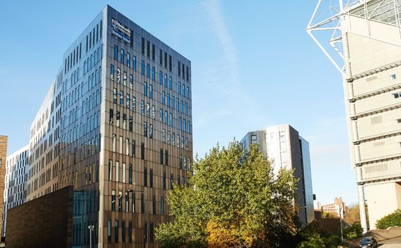 the outside of the Business School buildings on a sunny day	