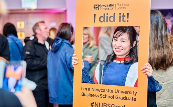 Newcastle University Business School graduate celebrating with a 