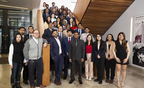 The NUBS MBA cohort for 2022-23 stood on the stairs in the Business School foyer.