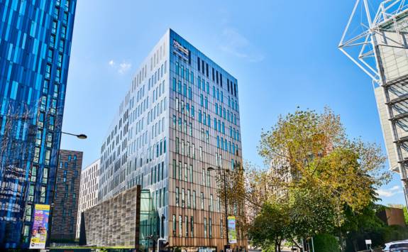 Newcastle University Business School main building seen from Barrack Road on a sunny day