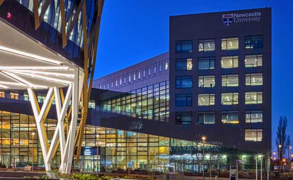 The Urban Sciences Building at the Newcastle Helix site, at dusk, illuminated with lights.