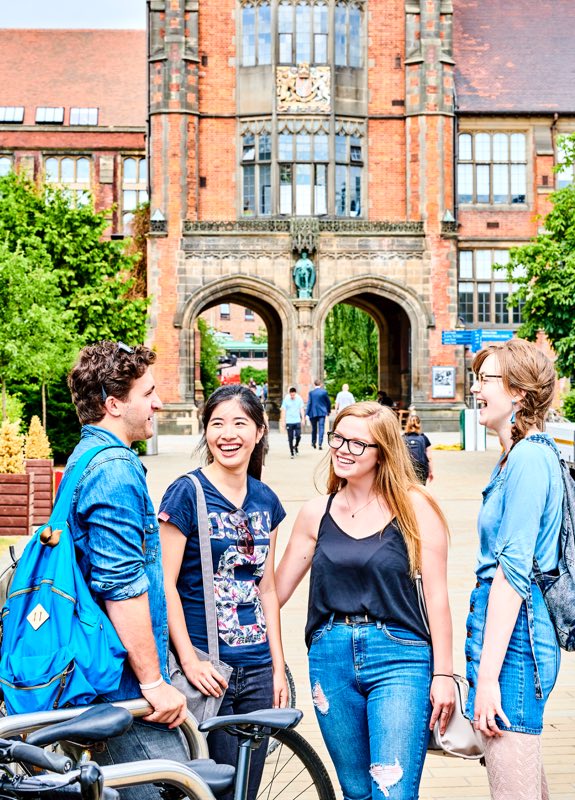 A diverse mix of students sat outside Newcastle University