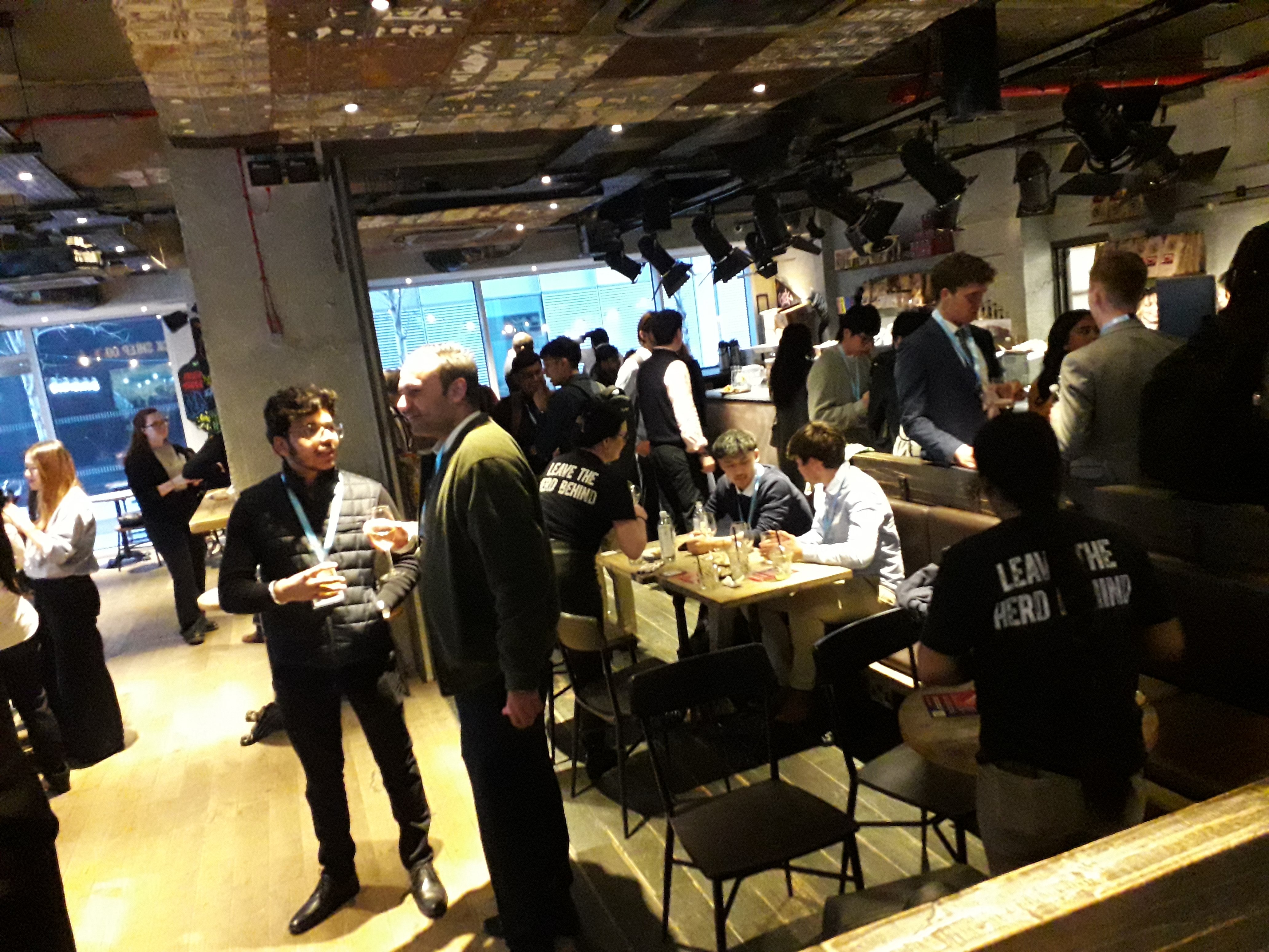 Photo taken inside Black Sheep coffee at Networking event, showing students engaged in discussion with alumni
