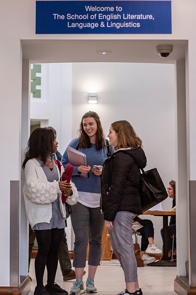 Three students talking together in the Percy foyer