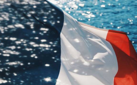 french flag with water in the background