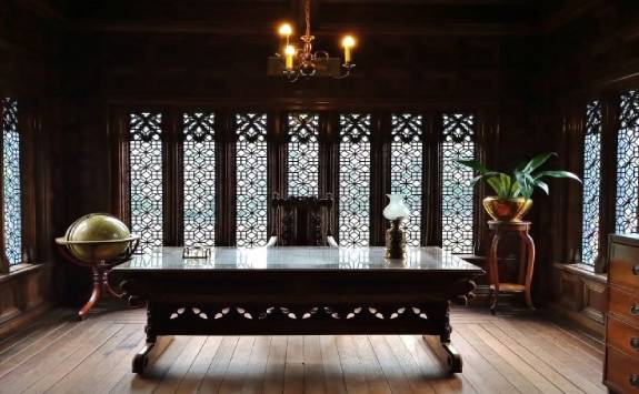 brown wooden table in the middle of a brown decorated room