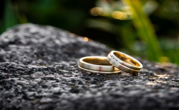 two wedding rings on a stone