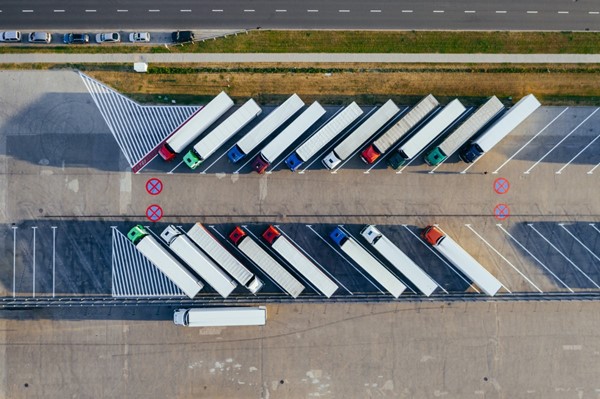 Ariel view of logistics trucks parked at a depot.