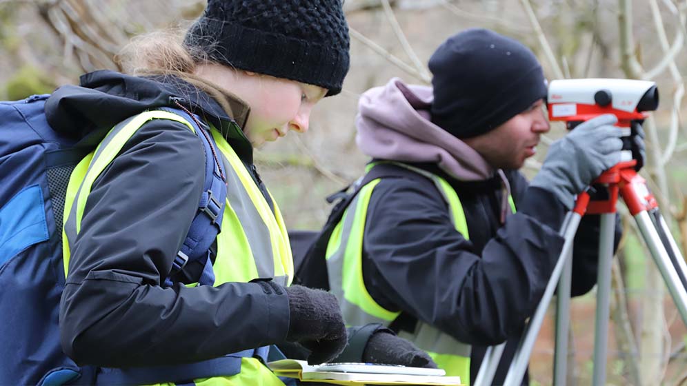 Geospatial students surveying the land during a practical project. 