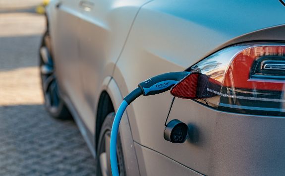 An electric car connected to a charging station.