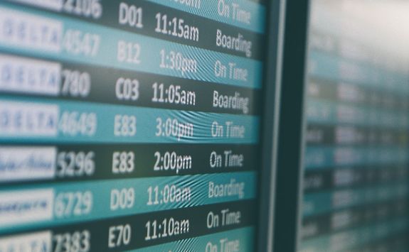 A travel information board showing departure times.