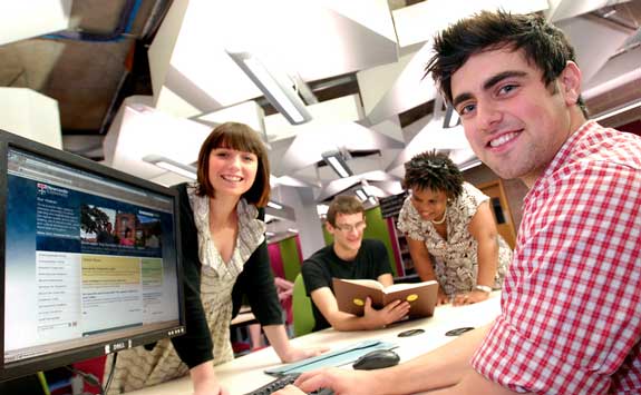 Postgraduate students studying in the Robinson Library