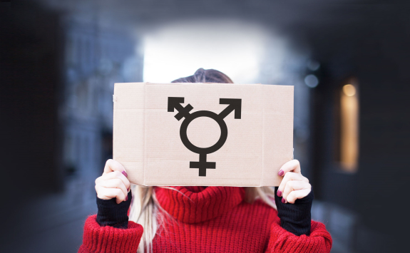 Person holding sign that represents gender