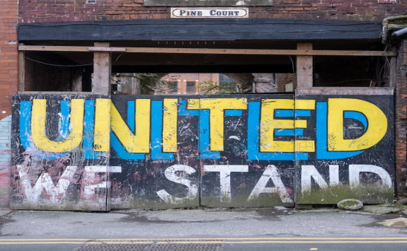 Wall in Leeds, UK, urban decay. It reads 'united we stand'