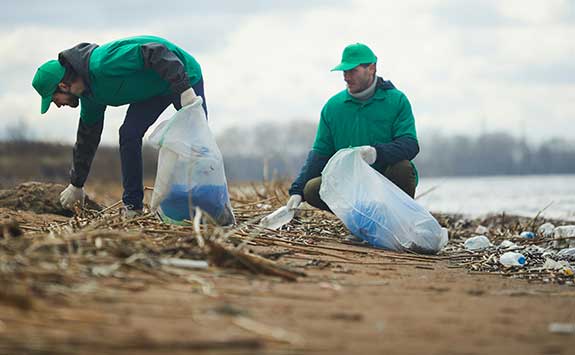 An environmental organisation clearing a beach of plastic rubbish.