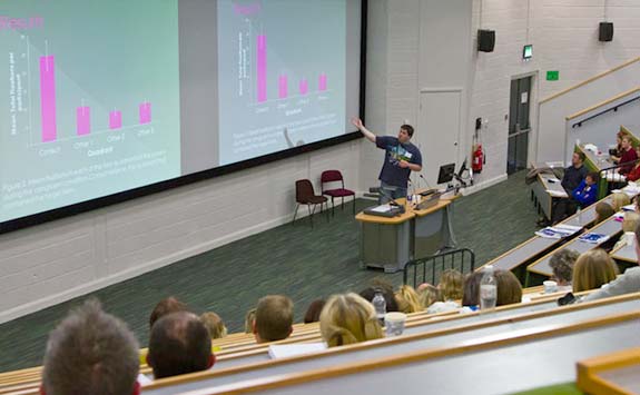 Students taking notes during a lecture.