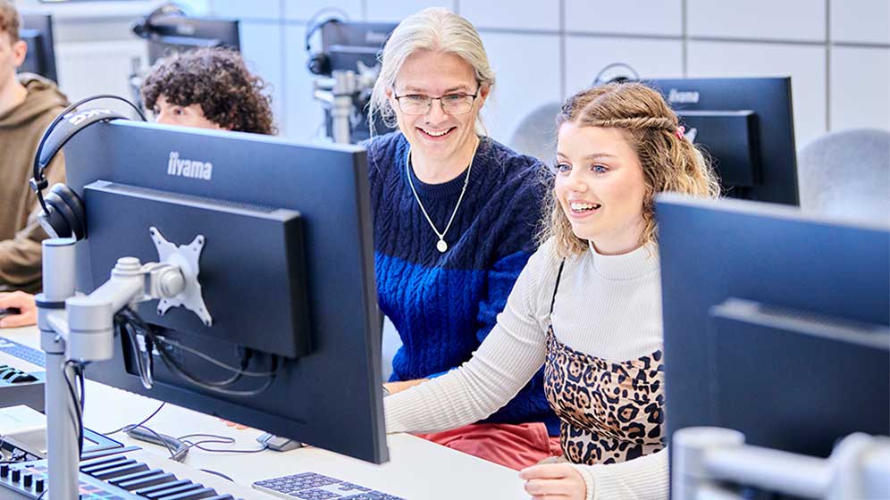 Music students working together on a computer