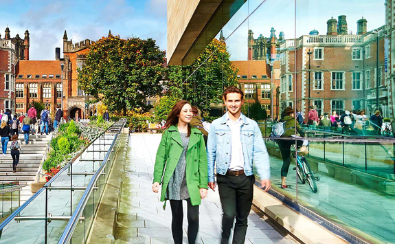 An image of two students walking through Newcastle University campus on a sunny day. 