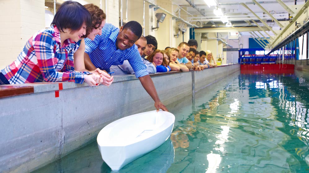 Students watch as lecturer uses towing tank